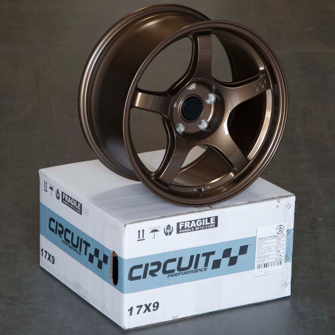 Circuit CSF5 Gloss bronze multi-spoke alloy wheel resting on a shipping box