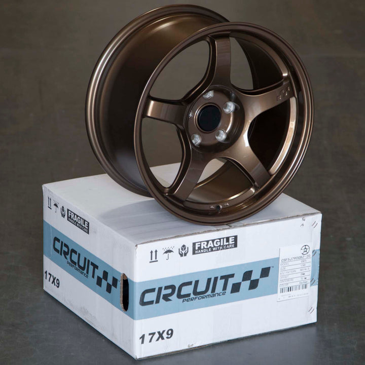 Circuit CSF5 Gloss bronze multi-spoke alloy wheel resting on a shipping box