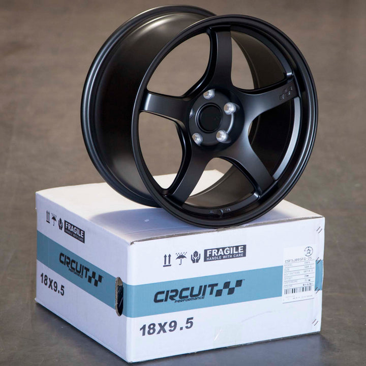 Matte gunmetal 5-spoke alloy Circuit CSF5 wheel with center cap, shown on box packaging