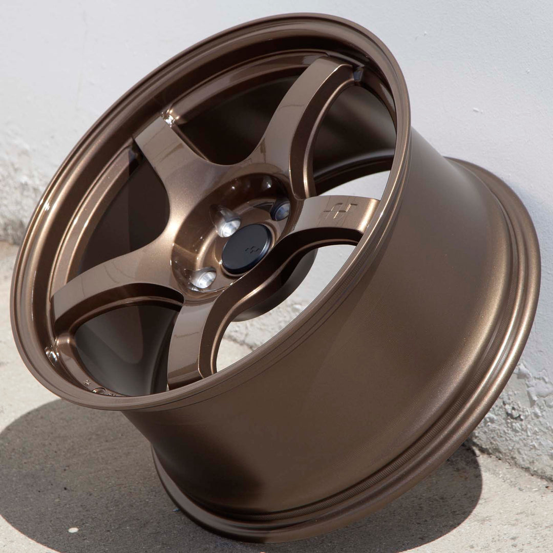 Circuit CSF5 Gloss bronze alloy wheel rim angled on ground, five spokes and center cap
