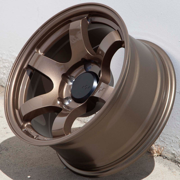 Circuit Steller Bronze alloy wheel with split spokes and center cap, side view outdoors